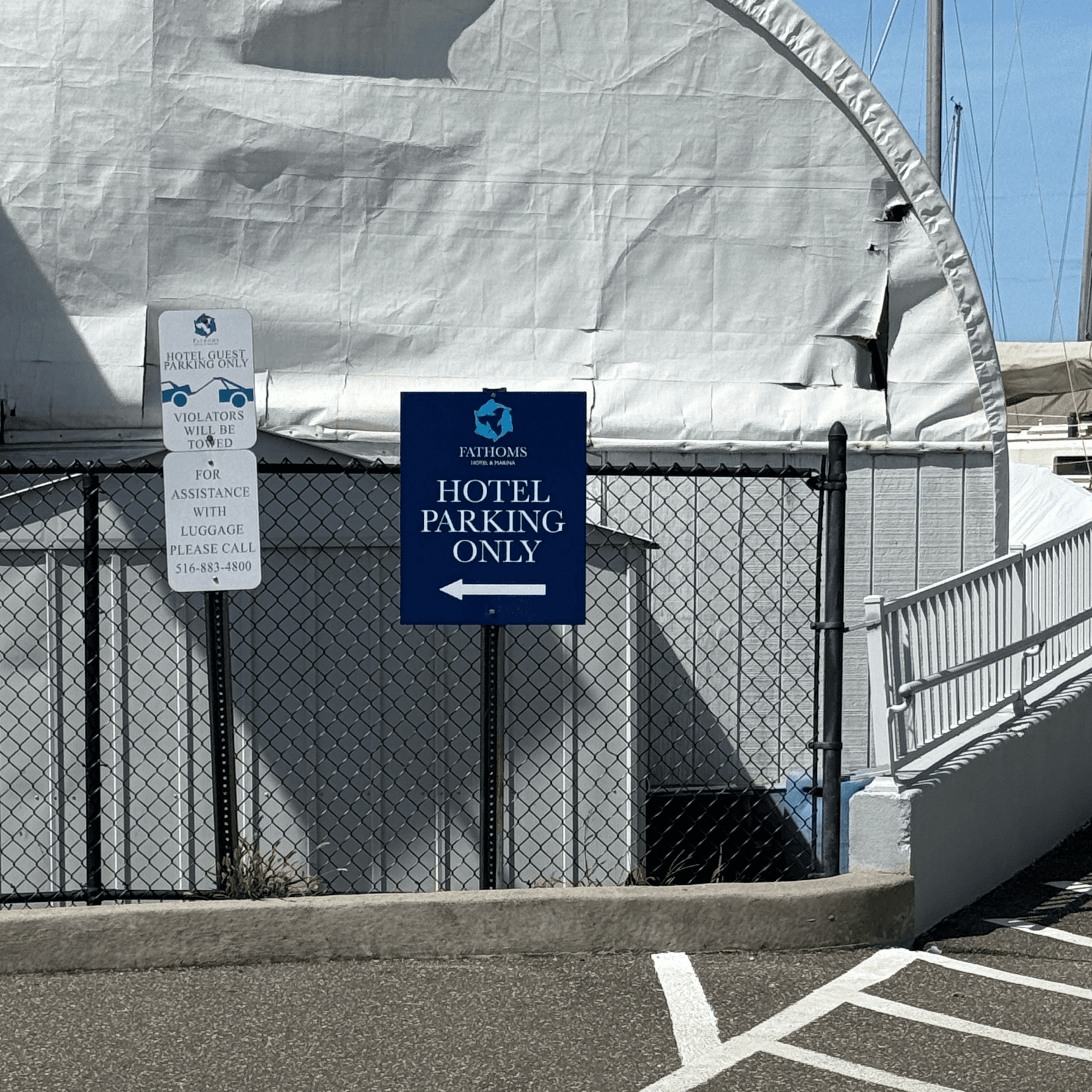 A blue and white sign that says Hotel Parking Only