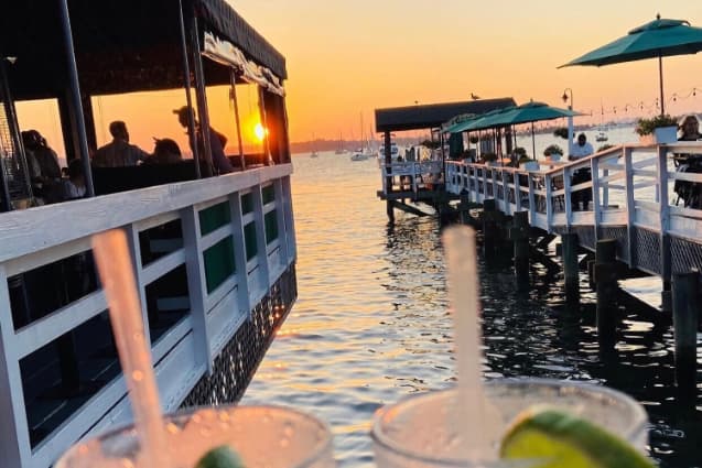 People dining at restaurants over a lake